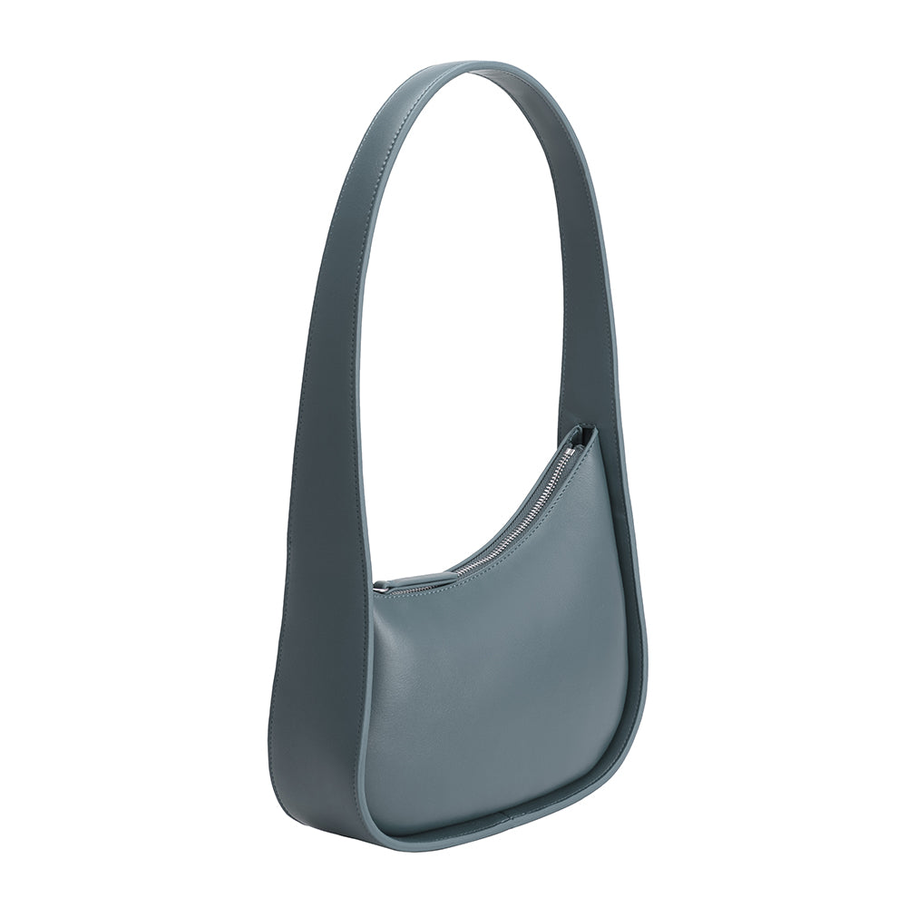 A slate asymmetrical vegan leather shoulder bag with a structured handle. 