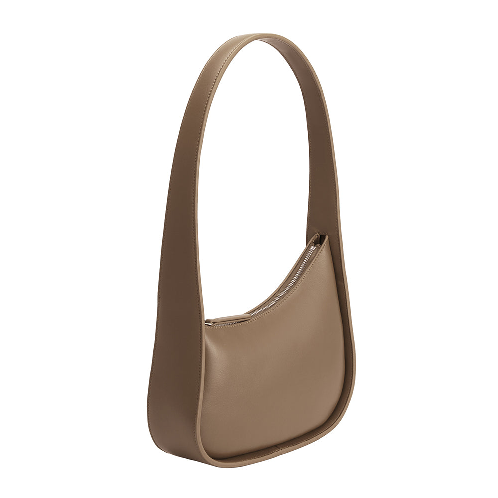 A taupe asymmetrical vegan leather structured shoulder bag.