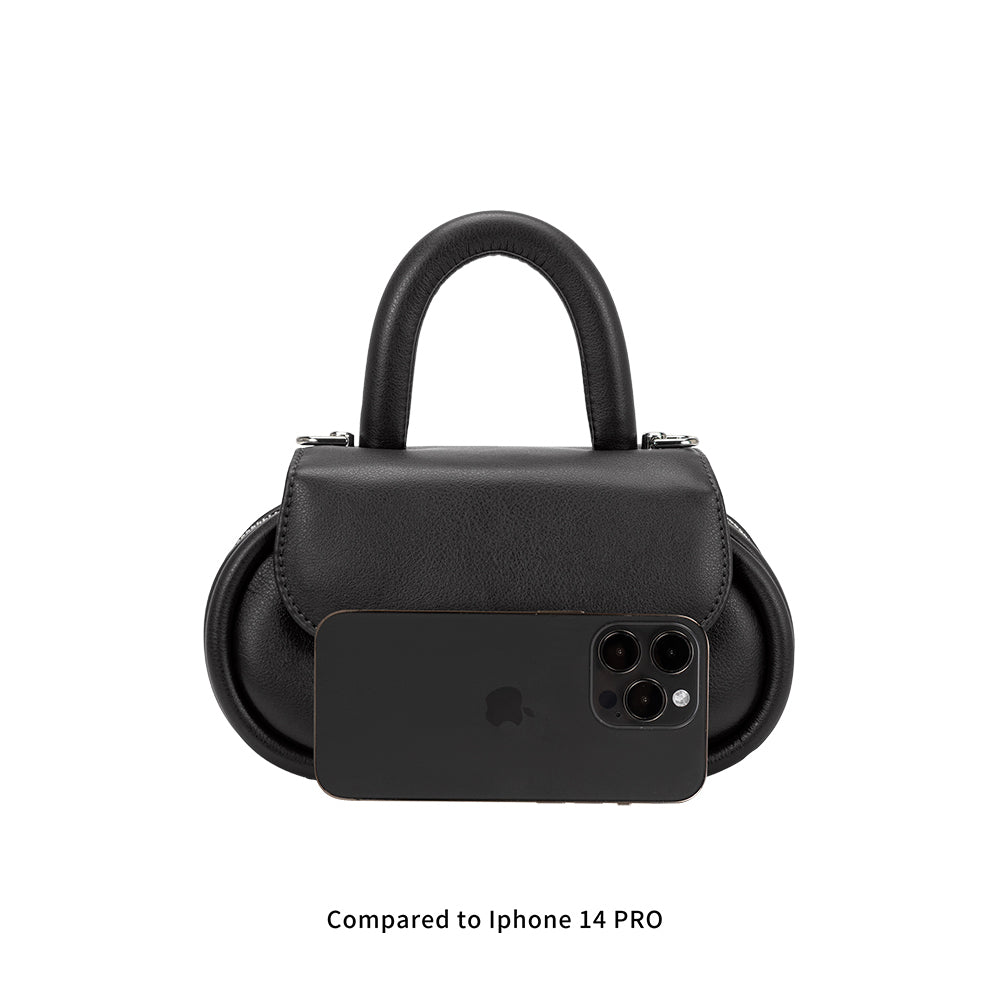 An Iphone 14 Pro size reference photo for a black oval shaped crossbody handbag.
