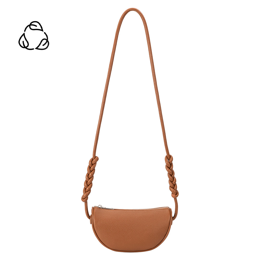 A small saddle crescent shape vegan leather crossbody bag with braided strap. 