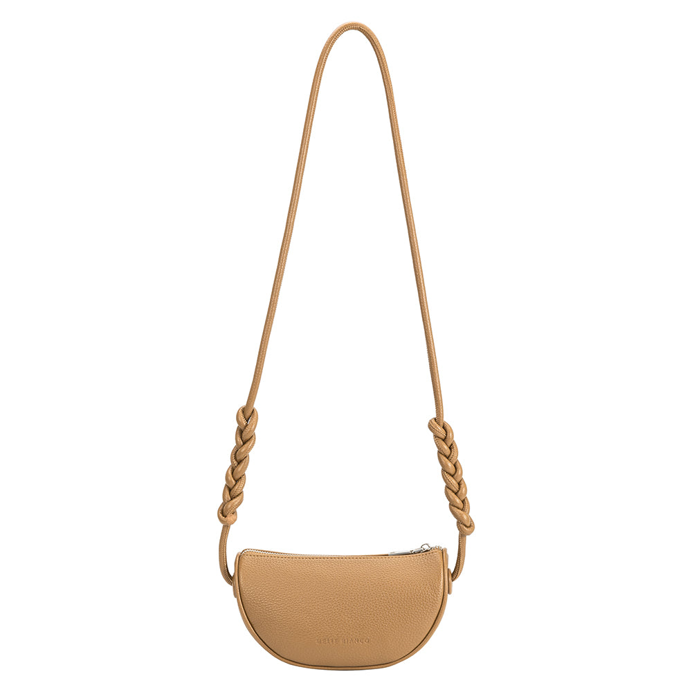 A small nude crescent shape recycled vegan leather crossbody bag with a braided strap