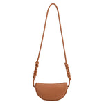 A small saddle crescent shaped vegan leather crossbody bag with a braided strap. 