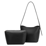 A black recycled vegan leather shoulder bag with adjustable strap.