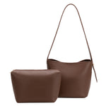 An espresso recycled vegan leather shoulder bag with adjustable strap with a zip pouch.
