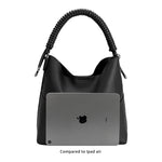 A ipad size comparison image for a pebble vegan leather tote bag with a spiral handle. 