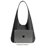 An ipad size comparison image for a large recycled vegan leather shoulder bag.