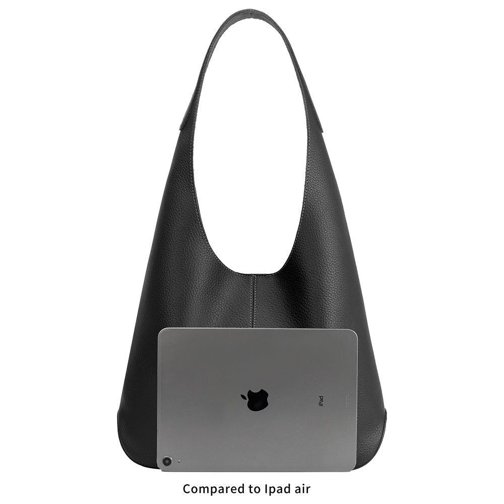 A laptop size comparison image for a large vegan leather shoulder bag.