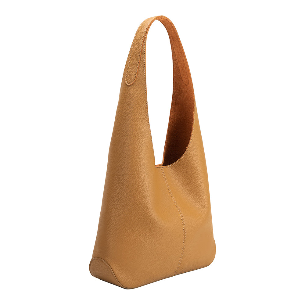 A large tan recycled vegan leather shoulder bag .