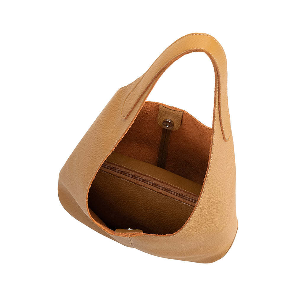 A large tan recycled vegan leather shoulder bag.