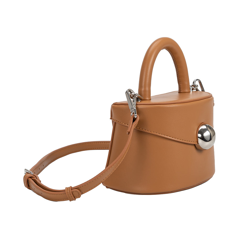 A small camel recycled vegan leather top handle bag with silver hardware.