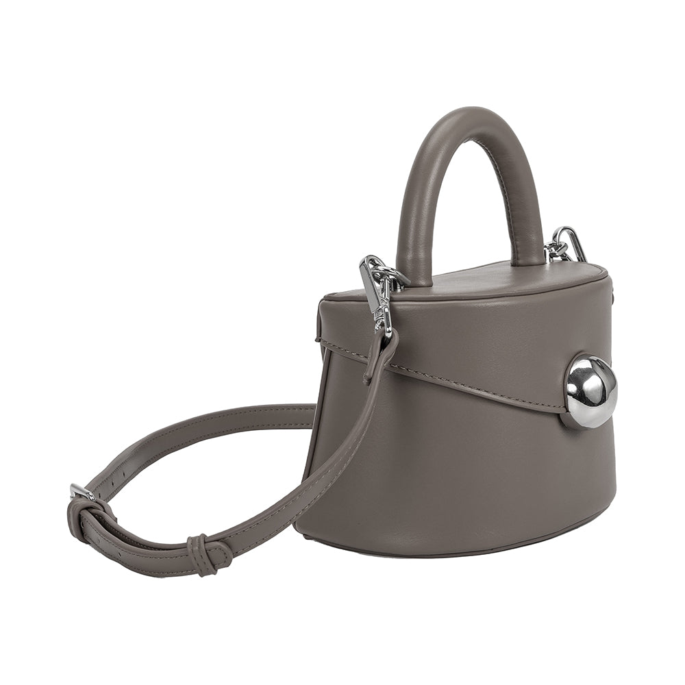 A small gray recycled vegan leather top handle bag with silver hardware, 