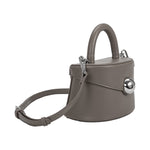 A small gray recycled vegan leather top handle bag with silver hardware, 