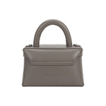 A small gray recycled vegan leather top handle bag with silver hardware. 