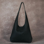 A still image of a large black recycled vegan leather shoulder bag.