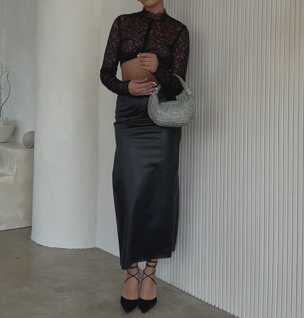 Video of a model wearing a small crystal encrusted crossbody bag.