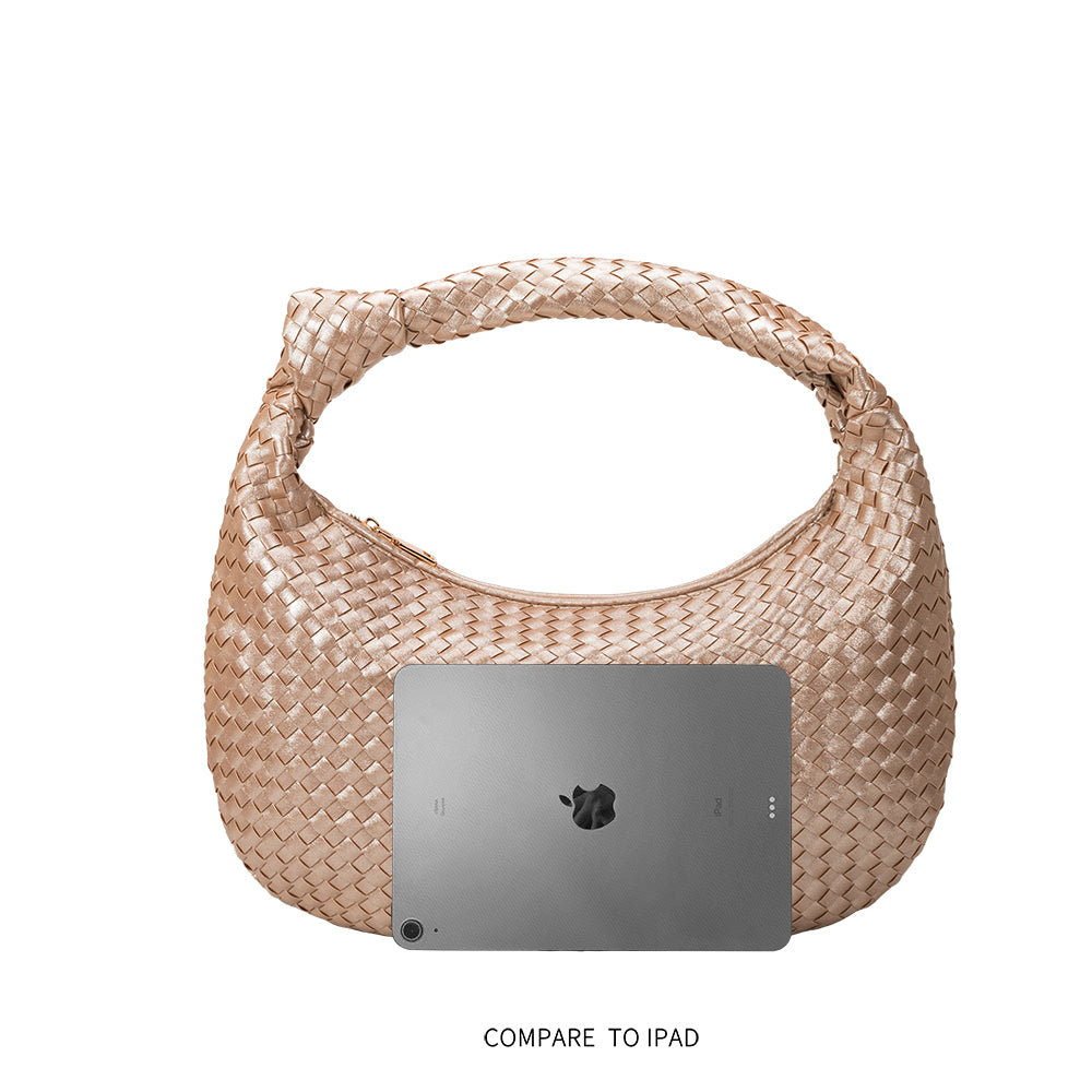 An ipad size comparison image for a large woven shoulder bag with a knot handle