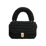 A black knitted crossbody handbag with a gold clasp. 