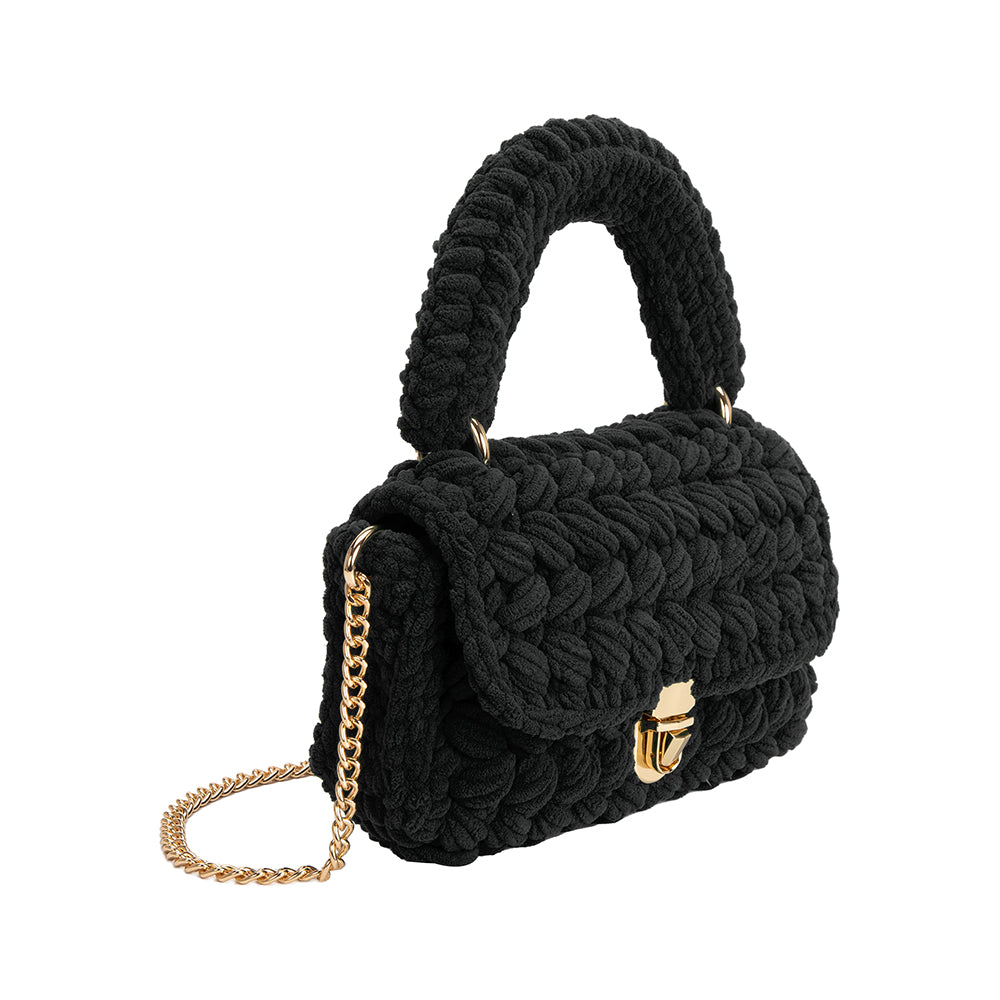 A black knitted crossbody handbag with a gold clasp. 