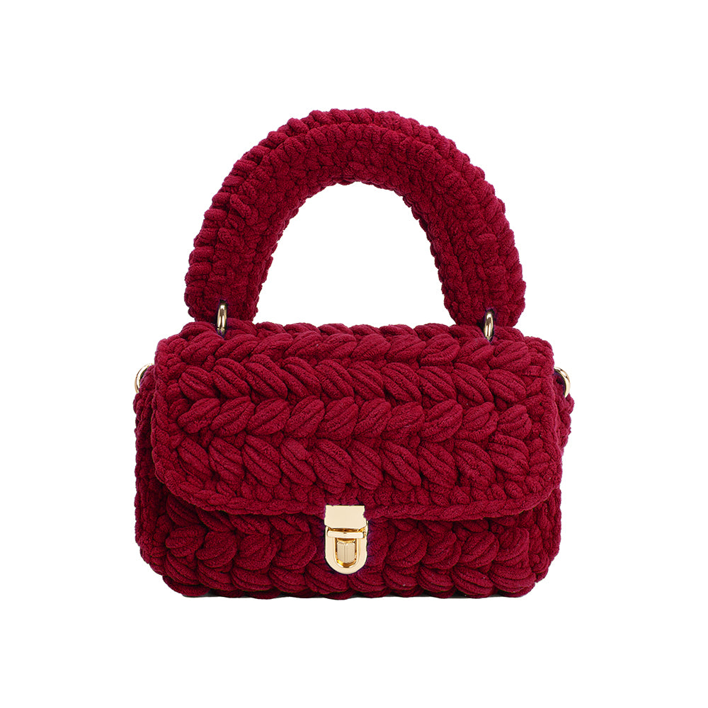 A plum knitted crossbody handbag with gold clasps.