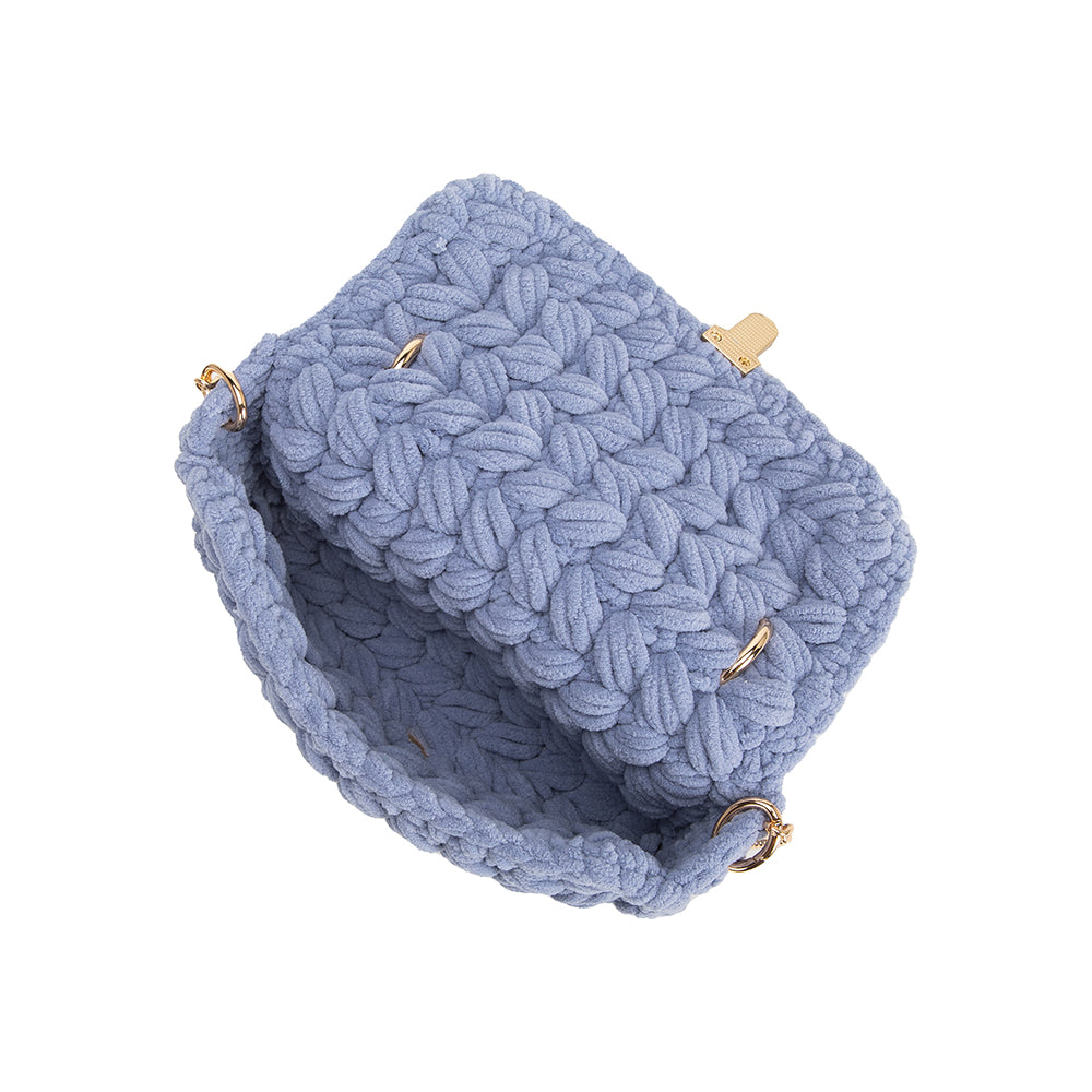 A sky knitted crossbody handbag with gold clasps.