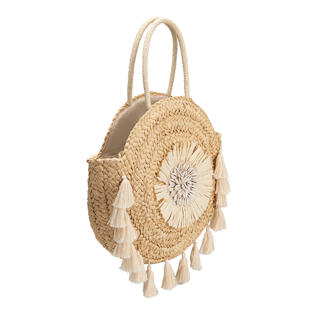 A large circular straw woven tote bag with seashell details and drawstring closure.