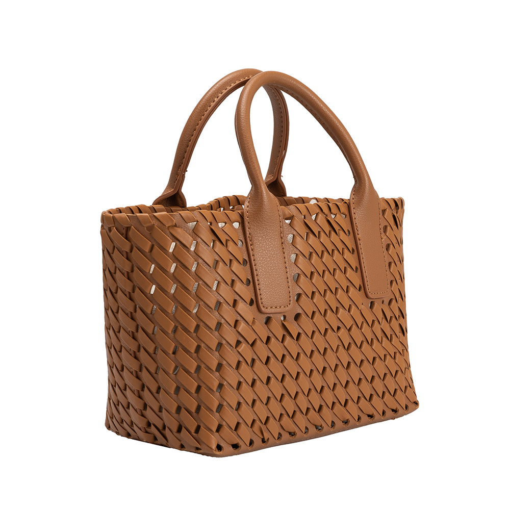 a small saddle woven vegan leather top handle bag with a drawstring closure.