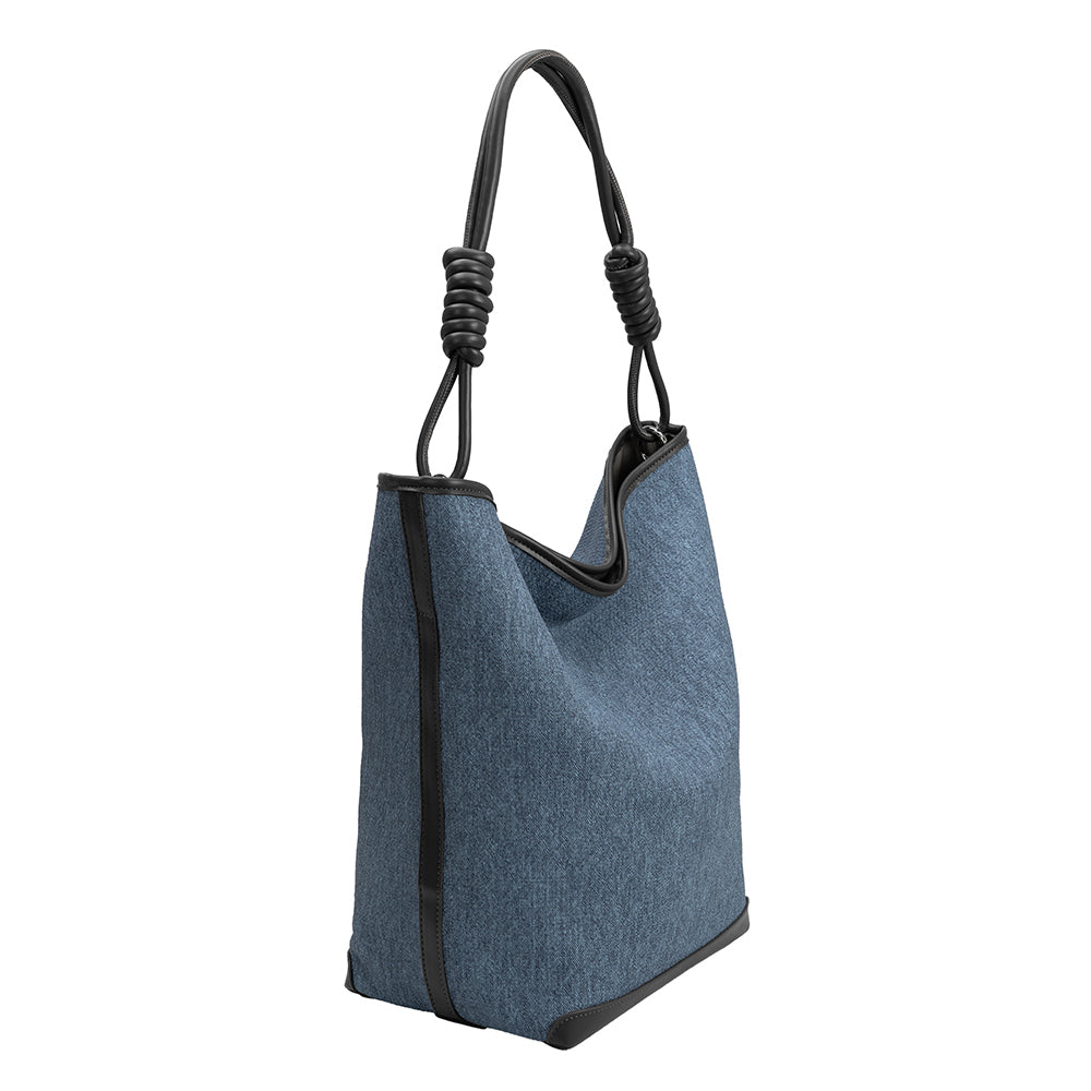 A large denim tote bag with black trimming and a knotted handle.