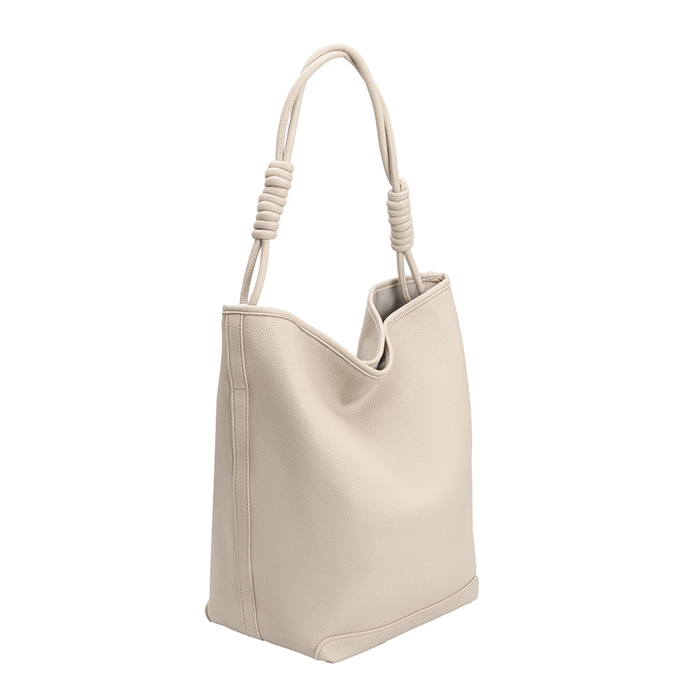 A large ivory vegan leather tote bag with a knotted handle.