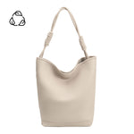 A large ivory vegan leather tote bag with a knotted handle.