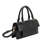 A small black vegan leather rectangle shaped top handle bag.