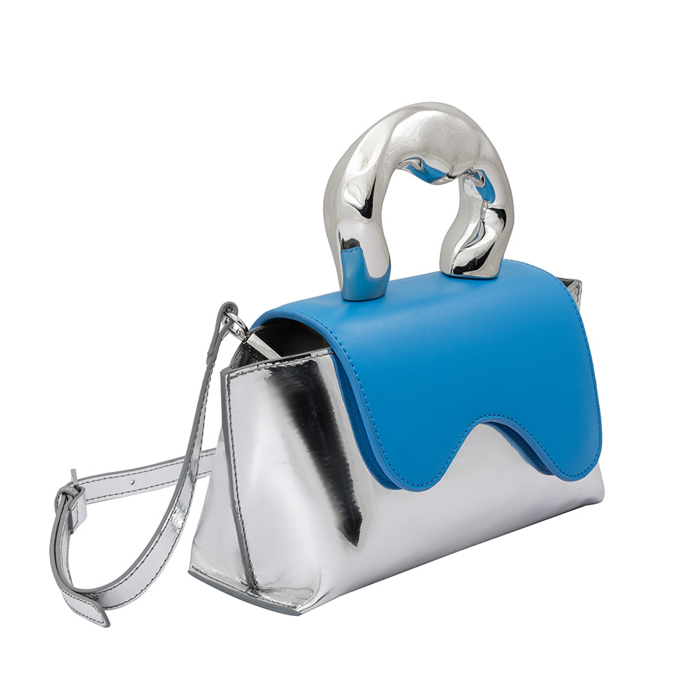 A small metallic vegan leather top handle bag with a wavy front flap closure.
