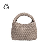 A small taupe hand woven vegan leather top handle bag.