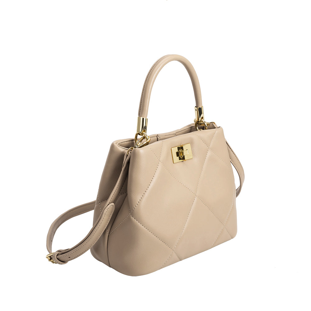 A mushroom crossbody handbag with gold clasps. 