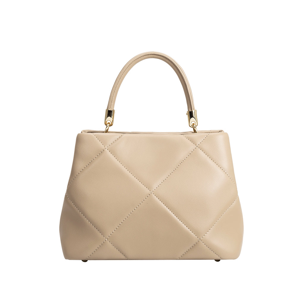 A mushroom crossbody handbag with gold clasps.