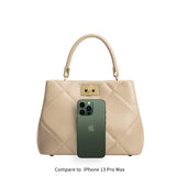 A nude top handle handbag with an Iphone 14 for space comparison. 