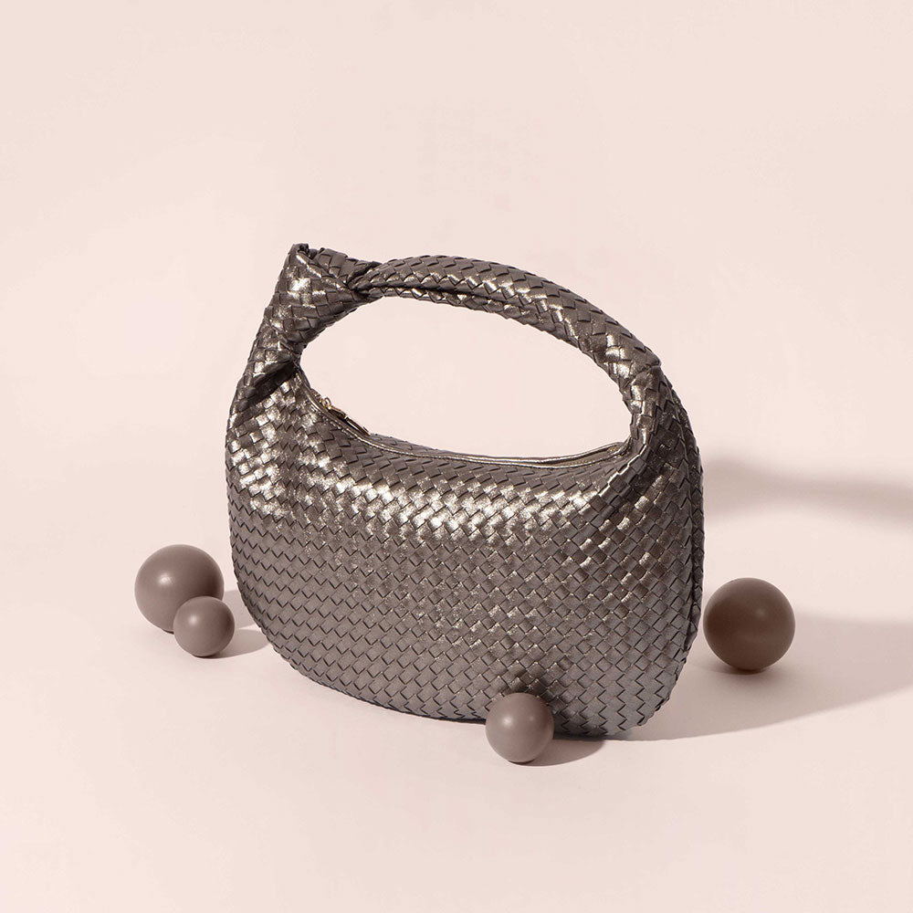A still photo of a metallic vegan leather shoulder bag. 