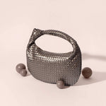 A still photo of a metallic vegan leather shoulder bag. 