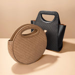 A still image of a square and circle woven recycled vegan leather top handle bag. 