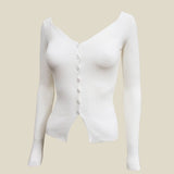 A white rib knit long sleeve cardigan.