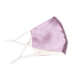 A satin lavender face mask with adjustable strings on each side. 