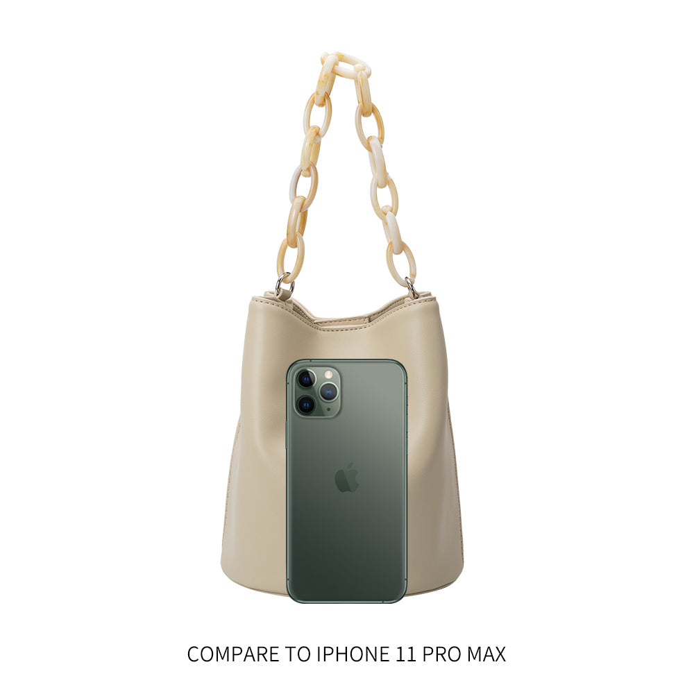 An iphone 11 pro size comparison image for a small recycled vegan leather crossbody bag with a acrylic chain. 