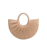 A small nude semi circle top handle bag with pleated details. 
