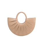  A small nude semi circle vegan leather top handle bag with pleated details.