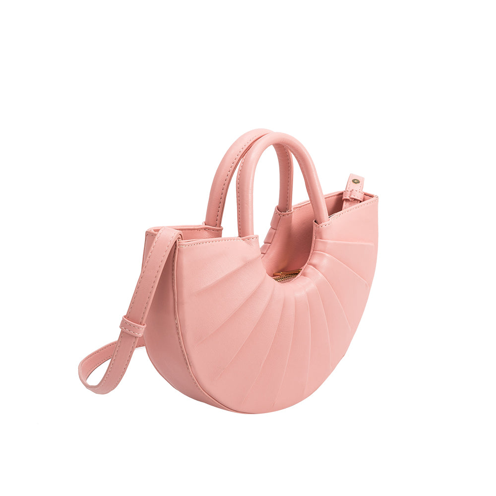 A small pink semi circle vegan leather top handle bag with pleated details.