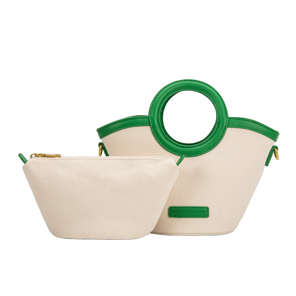 A small green canvas and vegan leather crossbody bag with a circle handle with a zip pouch.
