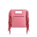 A square structured pink vegan leather crossbody bag with fringe on the side. 