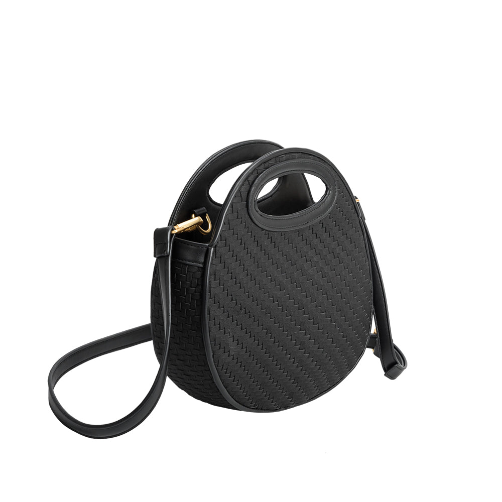 A black circle vegan leather crossbody bag with a woven pattern.
