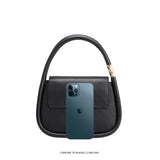An iphone 12 pro size comparison image for a structured vegan leather crossbody bag with double handles. 