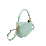 A small aqua structured vegan leather crossbody bag with a marble pearl accessory.