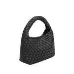 A small black hand woven vegan leather top handle bag.